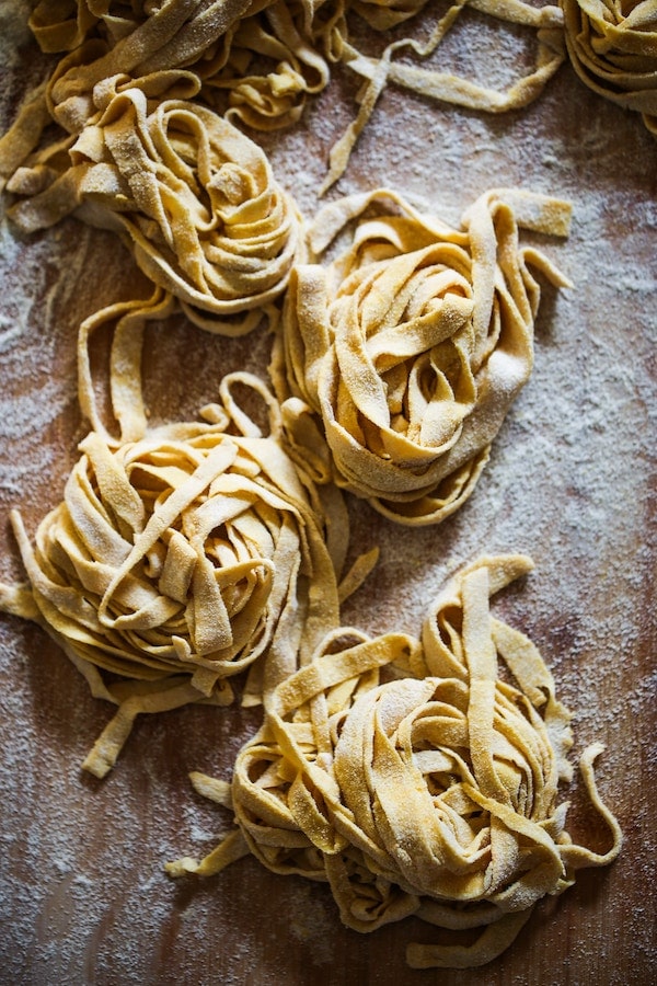 Fresh homemade tagliolini made with a chitarra pasta cutter at a